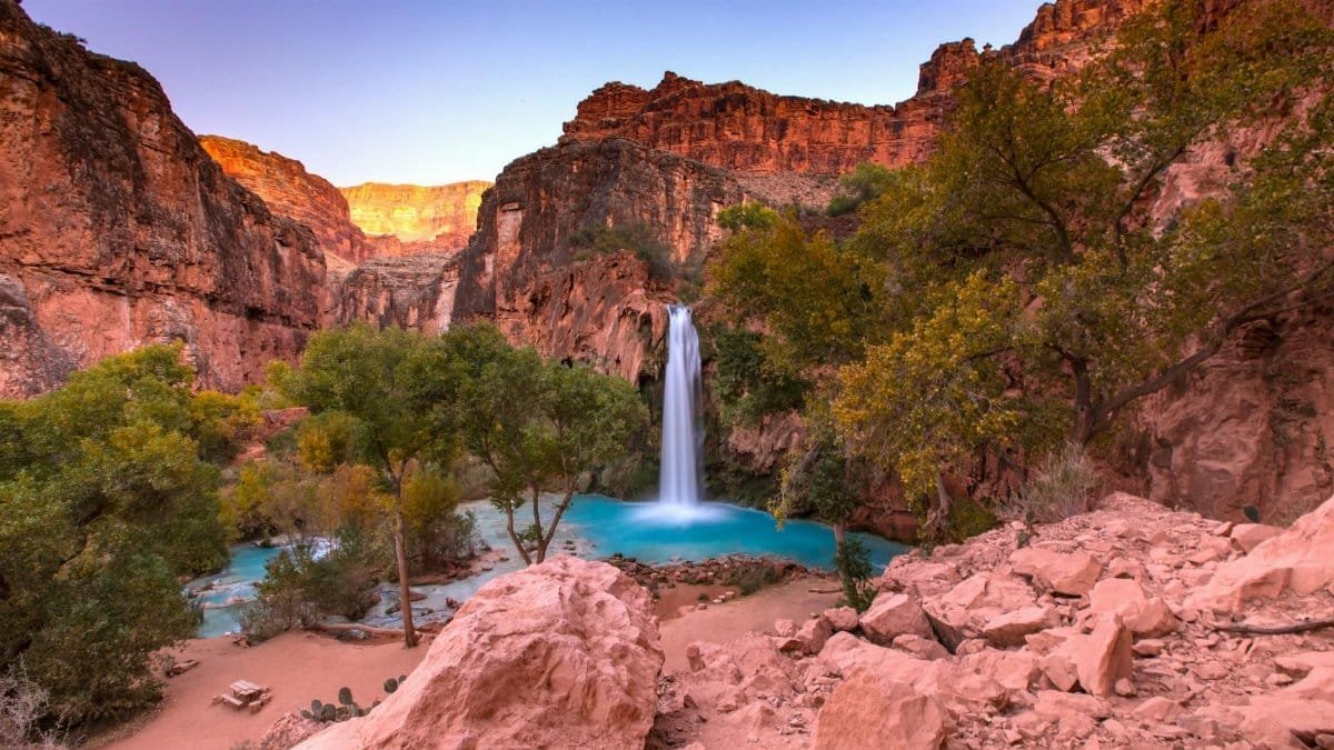 Havasu Falls cascades into a turquoise pool in Arizona's Grand Canyon.