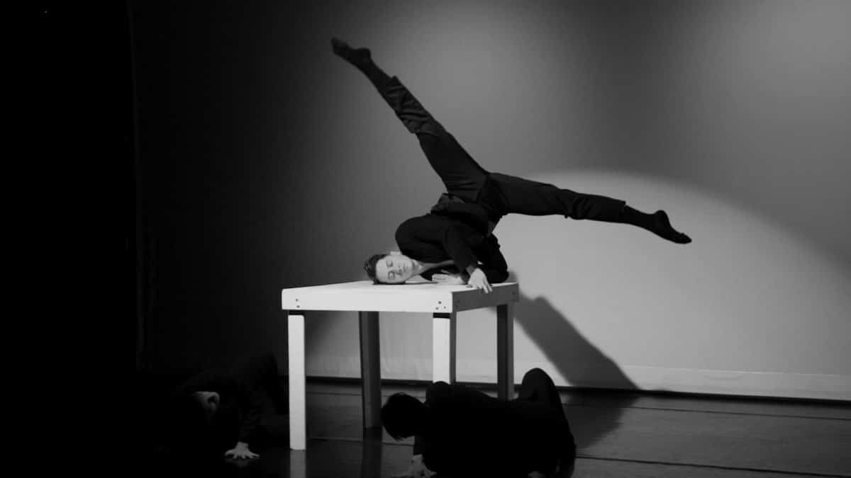 Artistic black and white photo of dancers during a performance on stage.