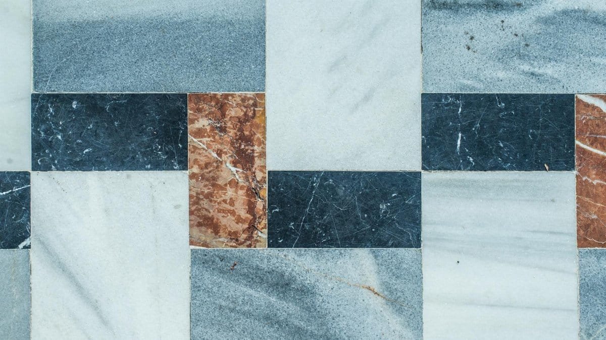 Close-up of a geometric marble tile pattern with natural texture colors.