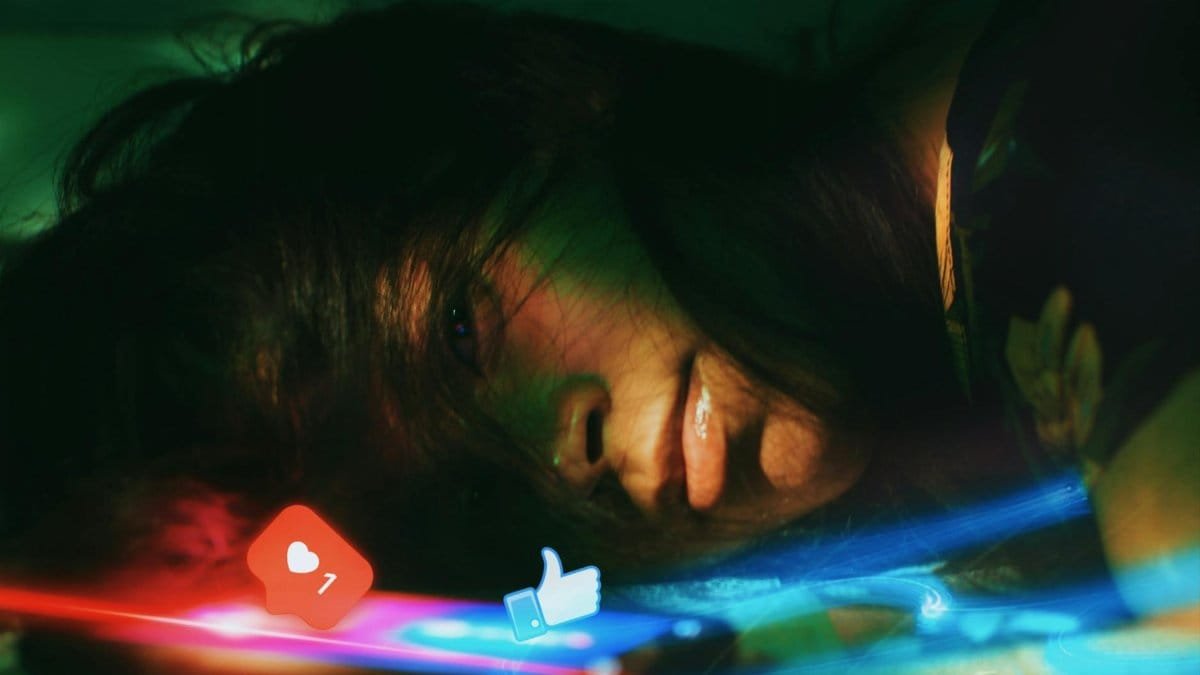 Artistic portrait of a woman expressing loneliness with social media icons in focus. Captivating light effects.