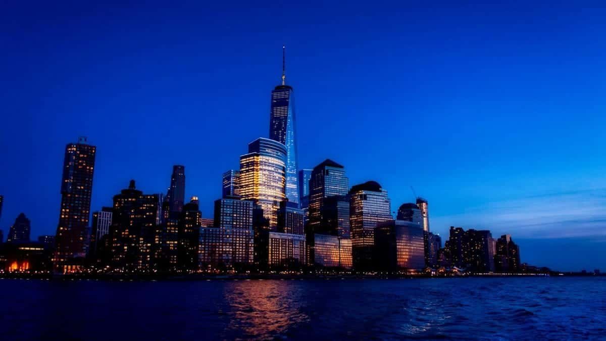Stunning view of Manhattan skyline featuring One World Trade Center at twilight.