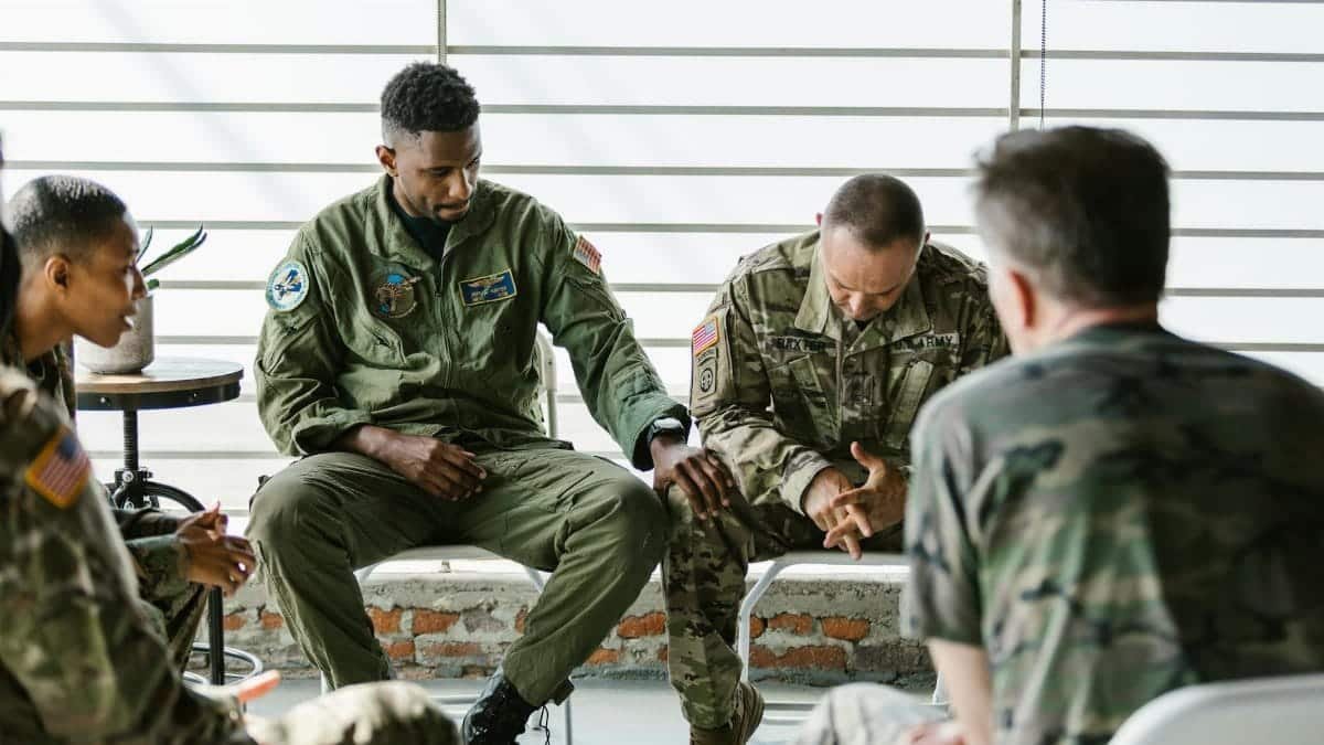 Soldiers in a supportive group therapy session focusing on mental health and recovery.