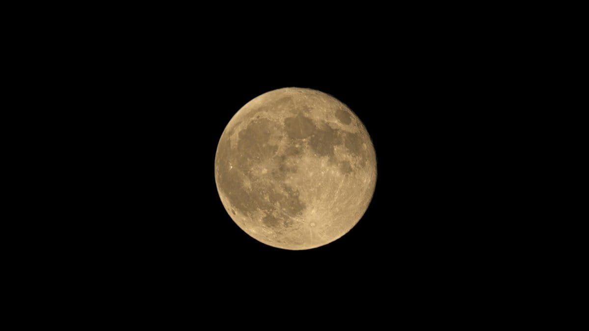 Bright full moon illuminating the night sky in Orthez, France.