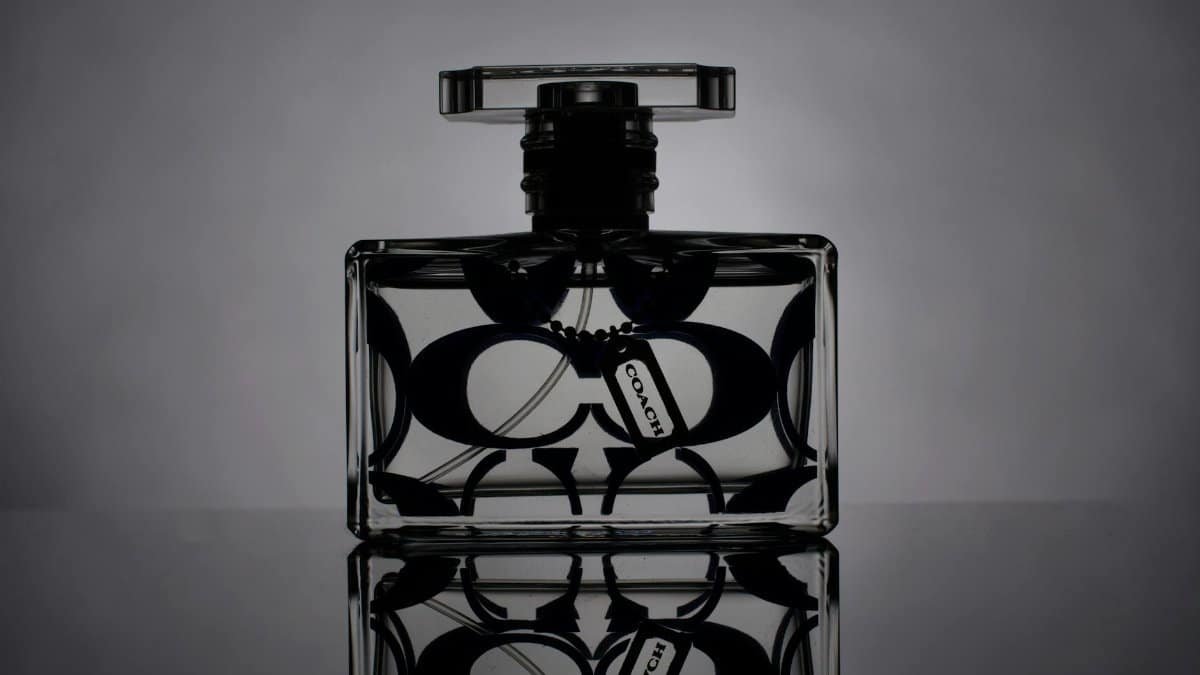 Artistic black and white shot of a designer perfume bottle with reflection.