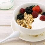 Delicious granola bowl topped with fresh berries and yogurt, perfect for a healthy breakfast.