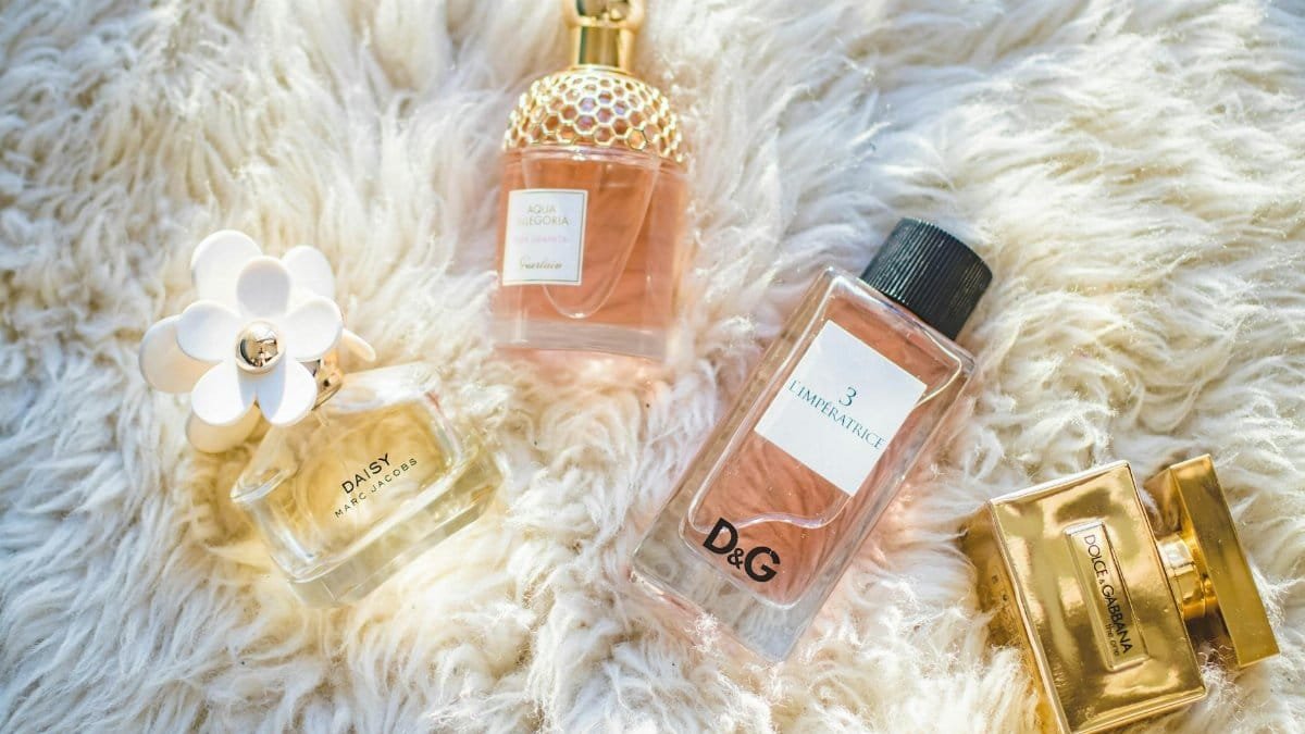 Elegant collection of perfume bottles on soft fur, highlighting luxury and style.