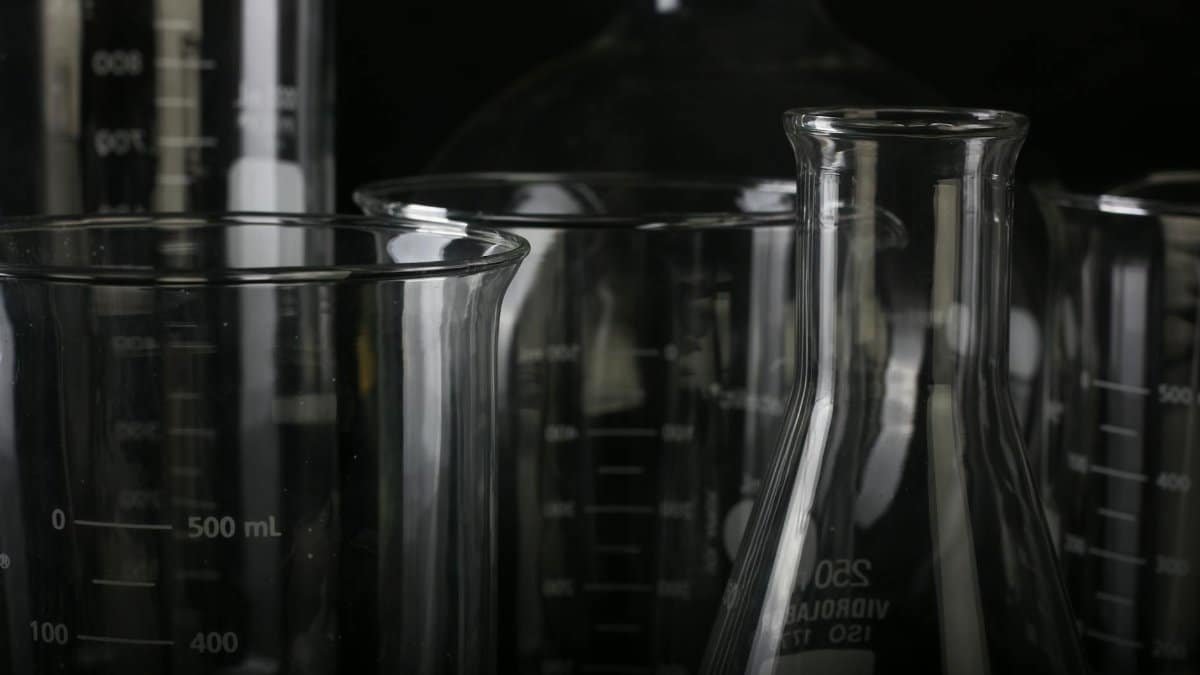 A detailed close-up of various transparent laboratory glassware used in scientific experiments.