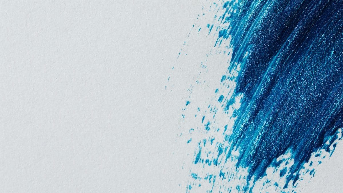 Abstract art with a bold blue brushstroke on a white canvas, perfect for modern decor.