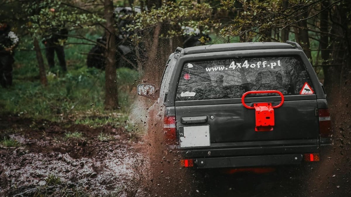 A thrilling off-road SUV adventure in a muddy forest, showcasing action and adventure with a 4x4 vehicle.