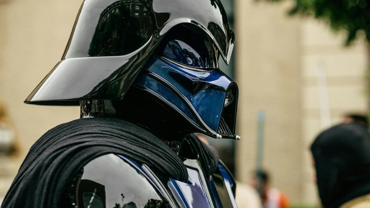 Detailed side view of a cosplayer dressed as Darth Vader at an event.