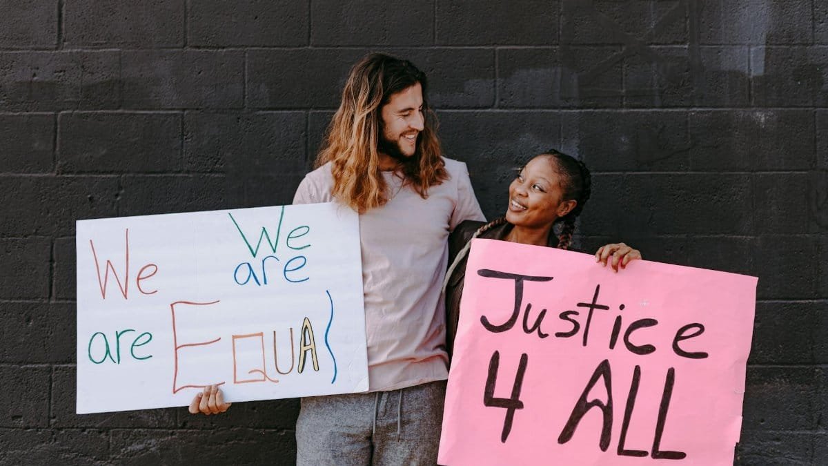 A diverse group of protesters holding signs advocating for equality and justice during a peaceful demonstration.