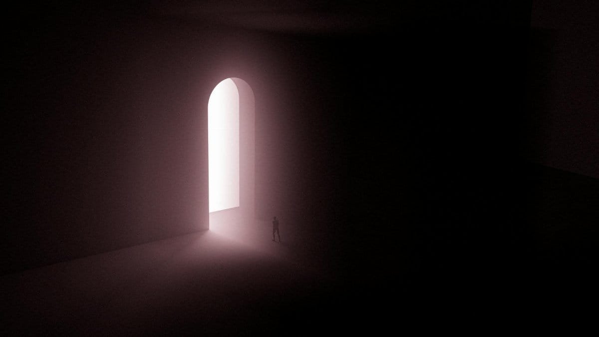 A surreal scene with a lone silhouette in front of an illuminated arched gateway.