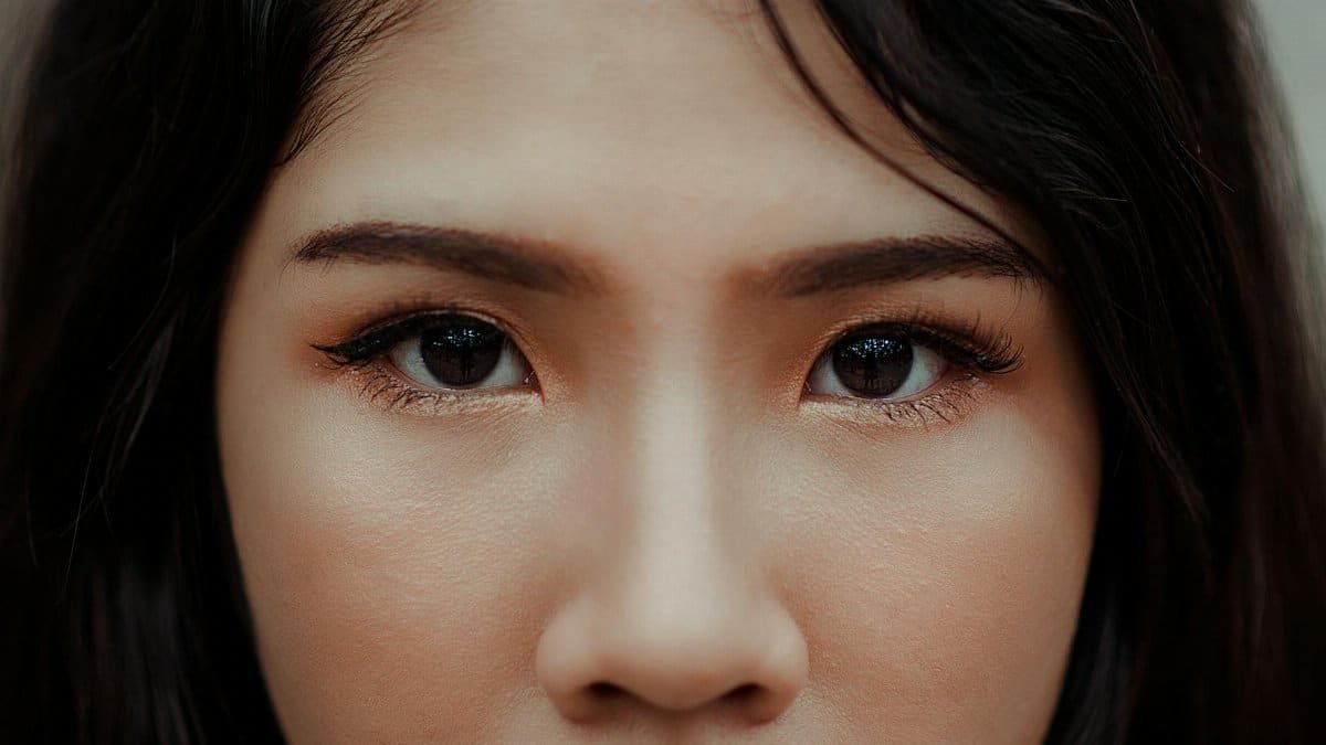A detailed close-up image showcasing the expressive eyes and natural beauty of a young woman.