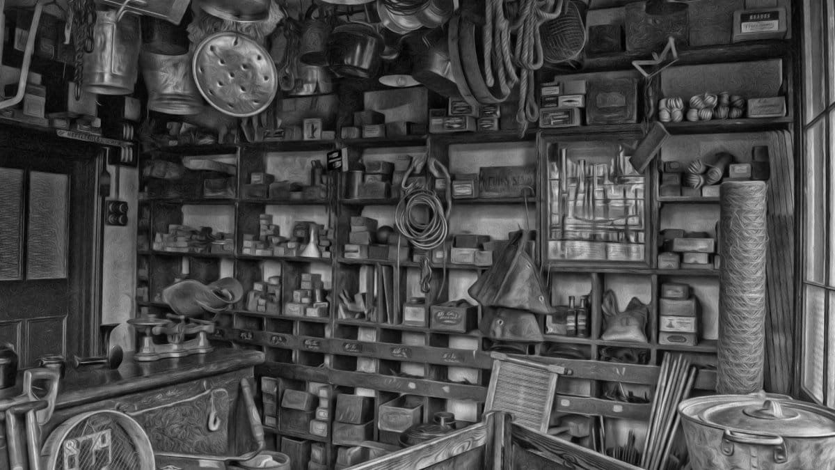 Monochromatic view of a vintage hardware store with assorted tools and kitchenware.
