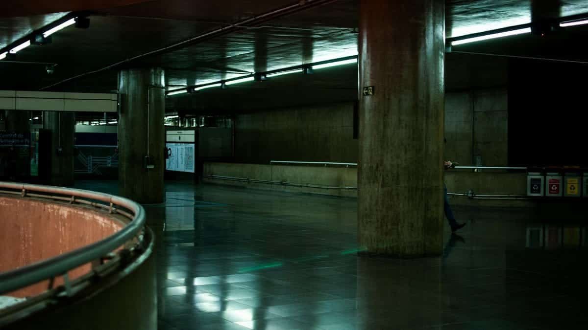 A modern underground parking garage showcasing sleek architecture and large supporting pillars.