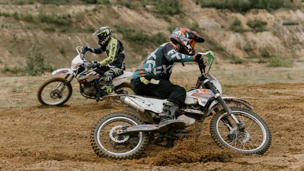 Exciting motocross action showcasing two riders tackling an off-road dirt track.