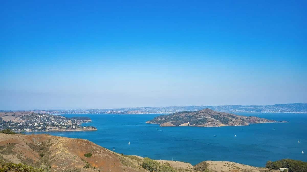 A stunning aerial view capturing a serene blue bay surrounded by distant islands, a perfect nature getaway.