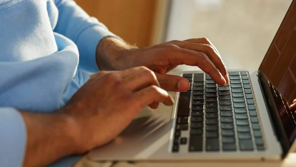 Focused image of hands typing on a laptop, ideal for business and tech themes.