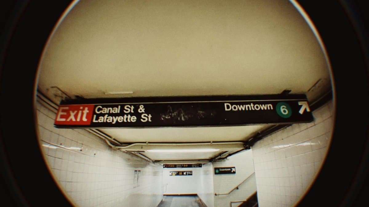 Fisheye view of New York subway corridor at Canal & Lafayette with exit sign.