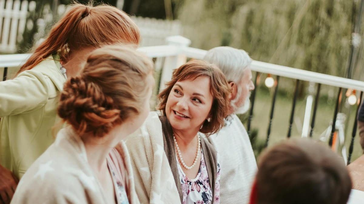 Family enjoying a cozy outdoor summer gathering with smiles and conversations.