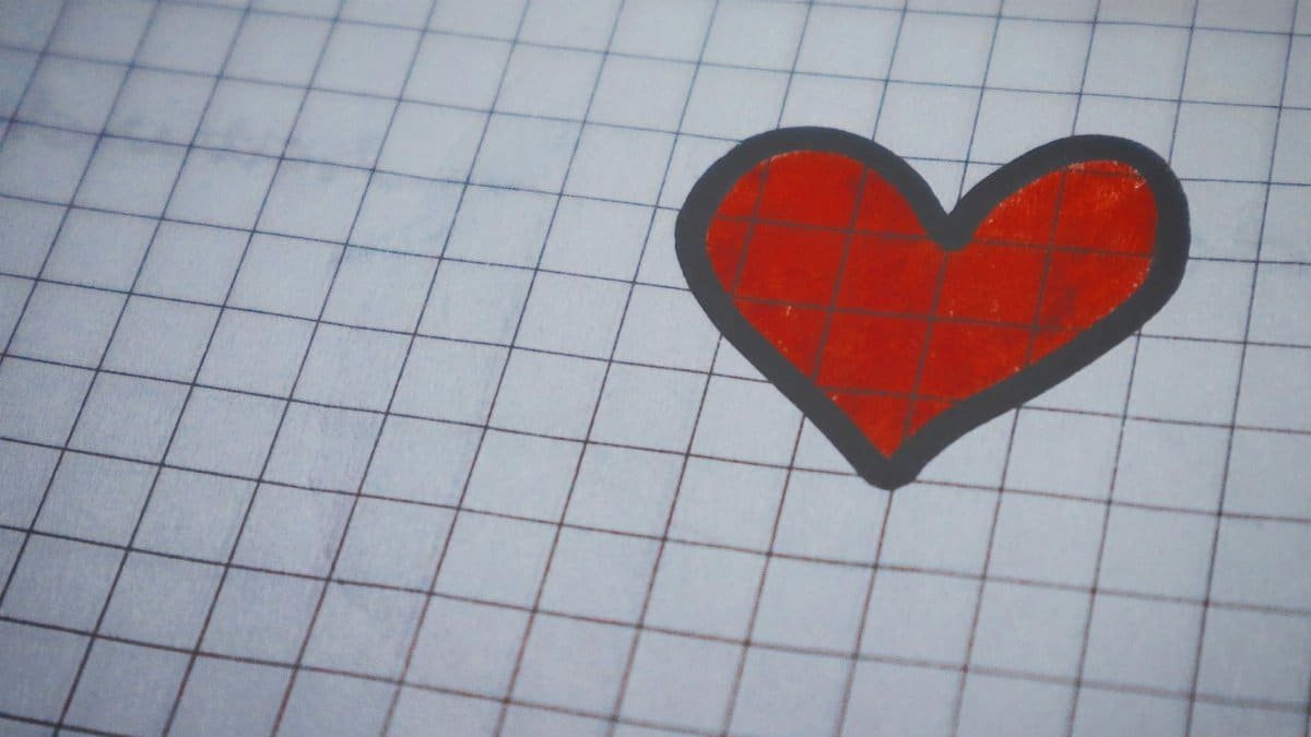 A red heart drawn on lined paper, perfect for Valentine's Day themes.