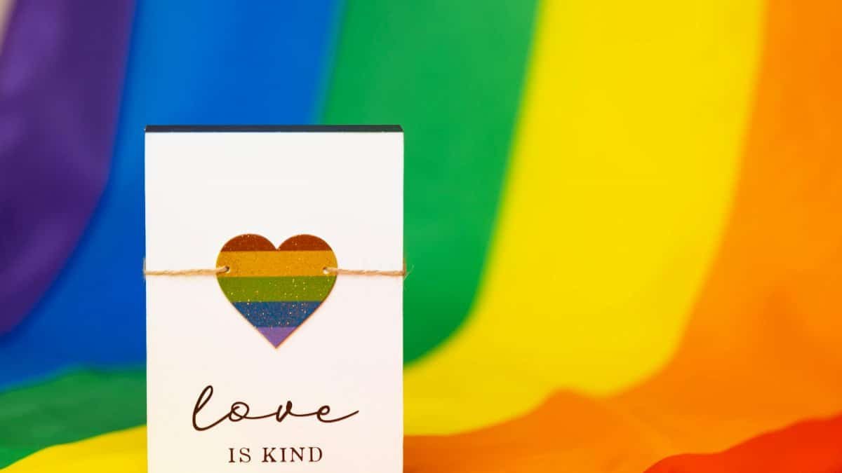 Card featuring a rainbow heart and 'Love is Kind' text on vibrant rainbow background.