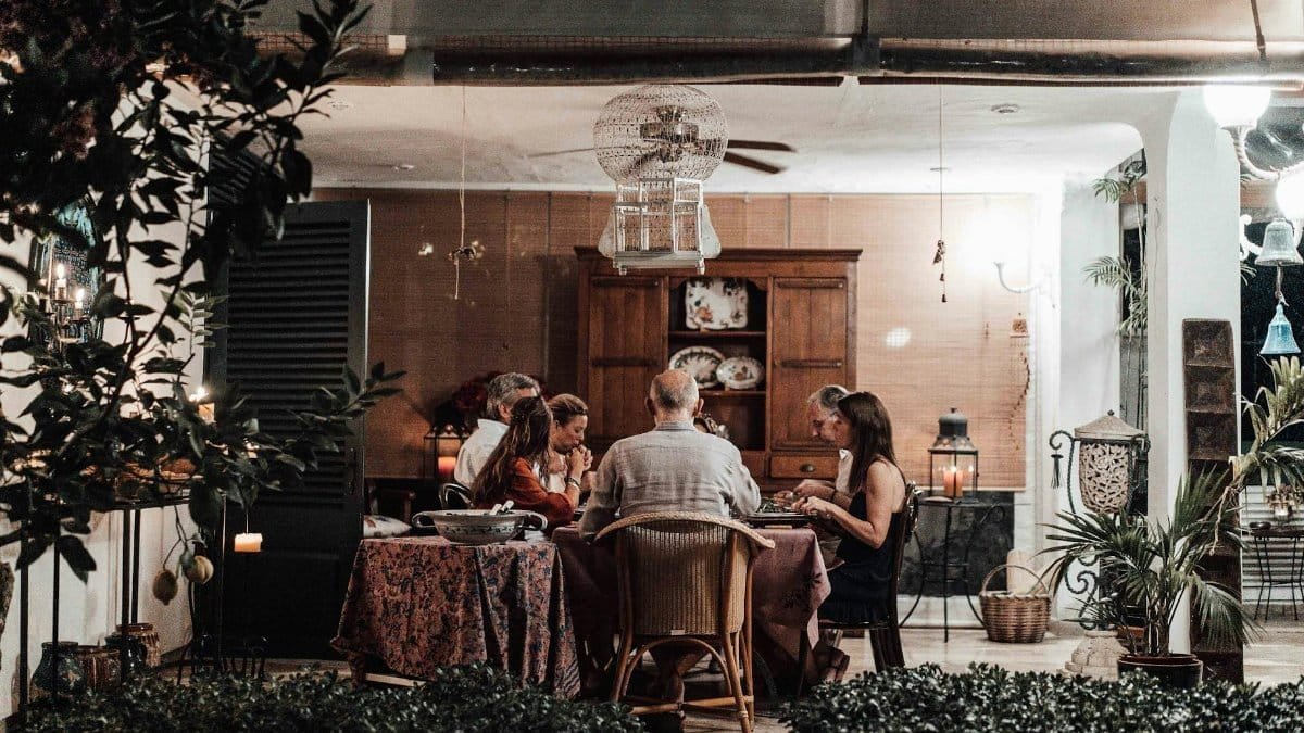A warm family dinner scene with candles, cozy atmosphere, and a shared meal indoors.