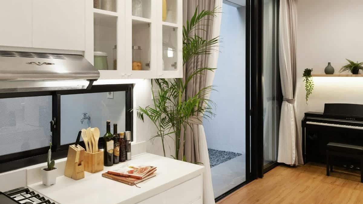 Elegant modern interior featuring a clean kitchen counter and a piano nook.