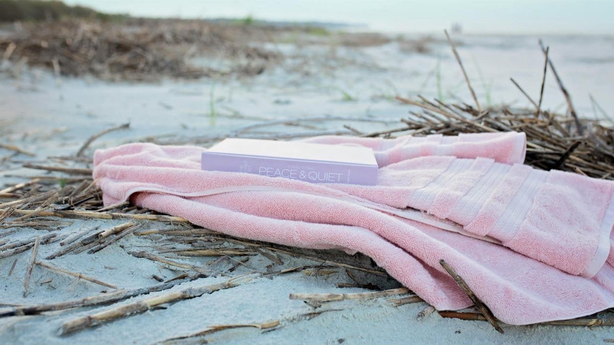Pink towel and book 'Peace & Quiet' on secluded beach, Hilton Head Island.