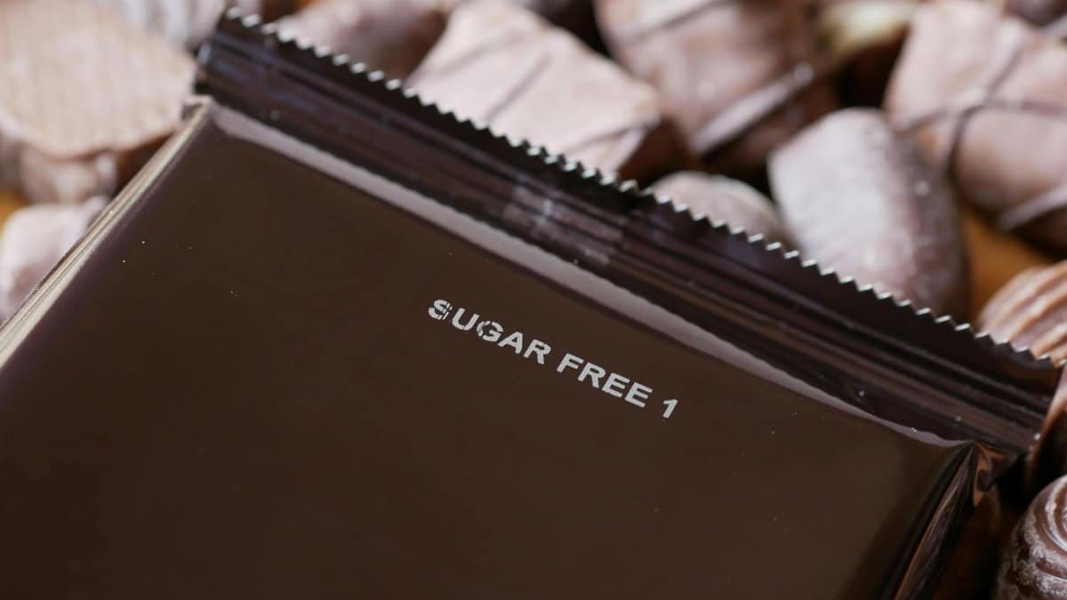 Close-up of sugar-free chocolate candies with a focus on a wrapped piece.