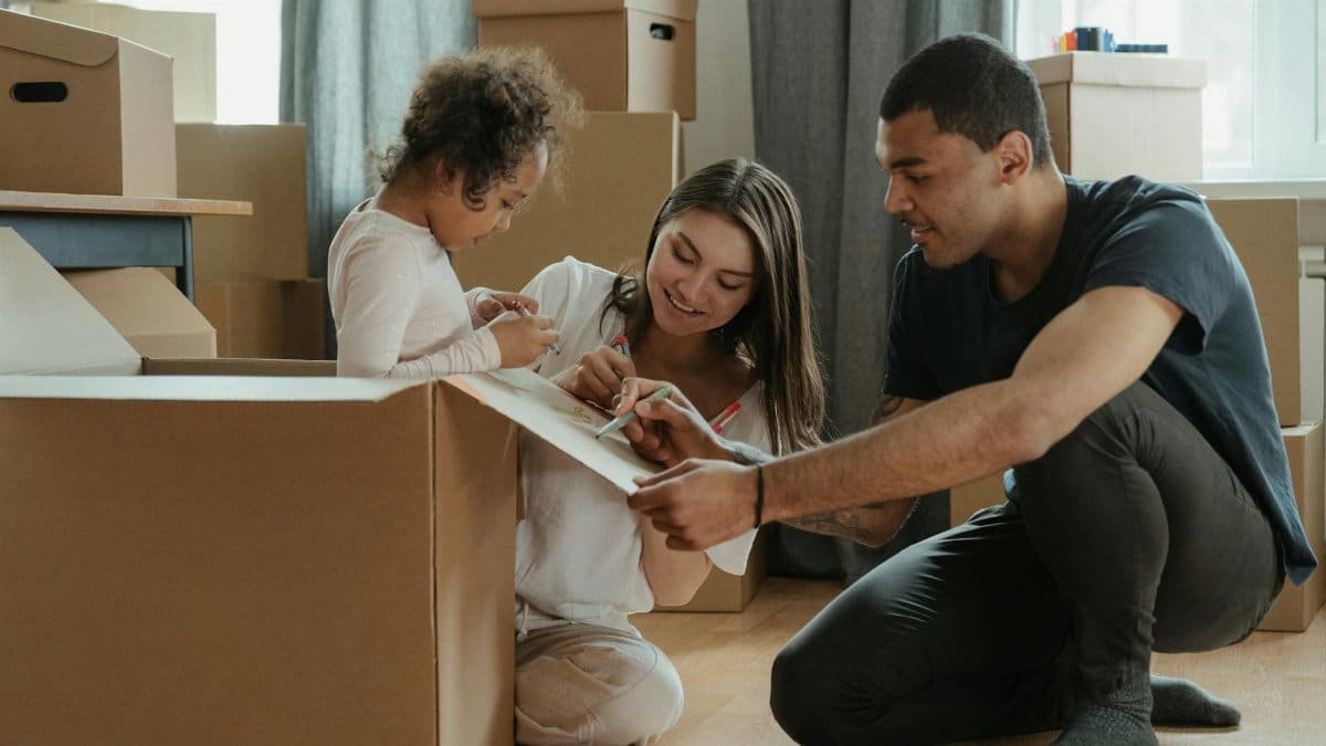 A family involved in a creative activity while moving into their new home.