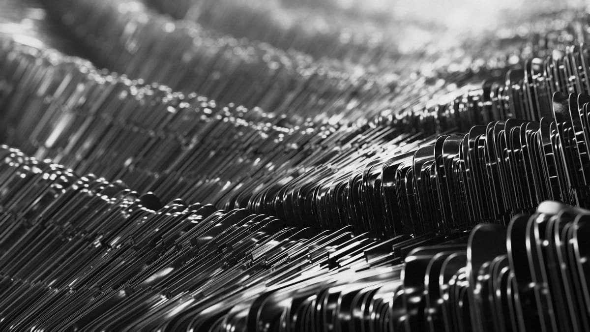 Intricate abstract pattern of metallic textures in black and white, showcasing modern design.