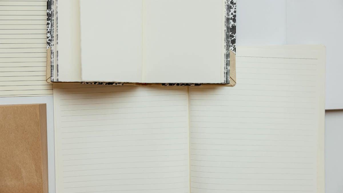 A variety of blank lined notebooks in a flat lay, perfect for writing and journaling inspiration.