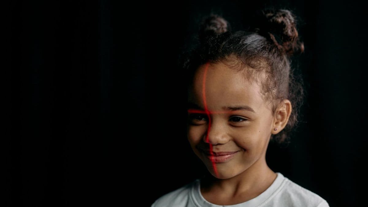 Charming portrait of a young girl in a studio setting, highlighted by a 3D scanning laser line.