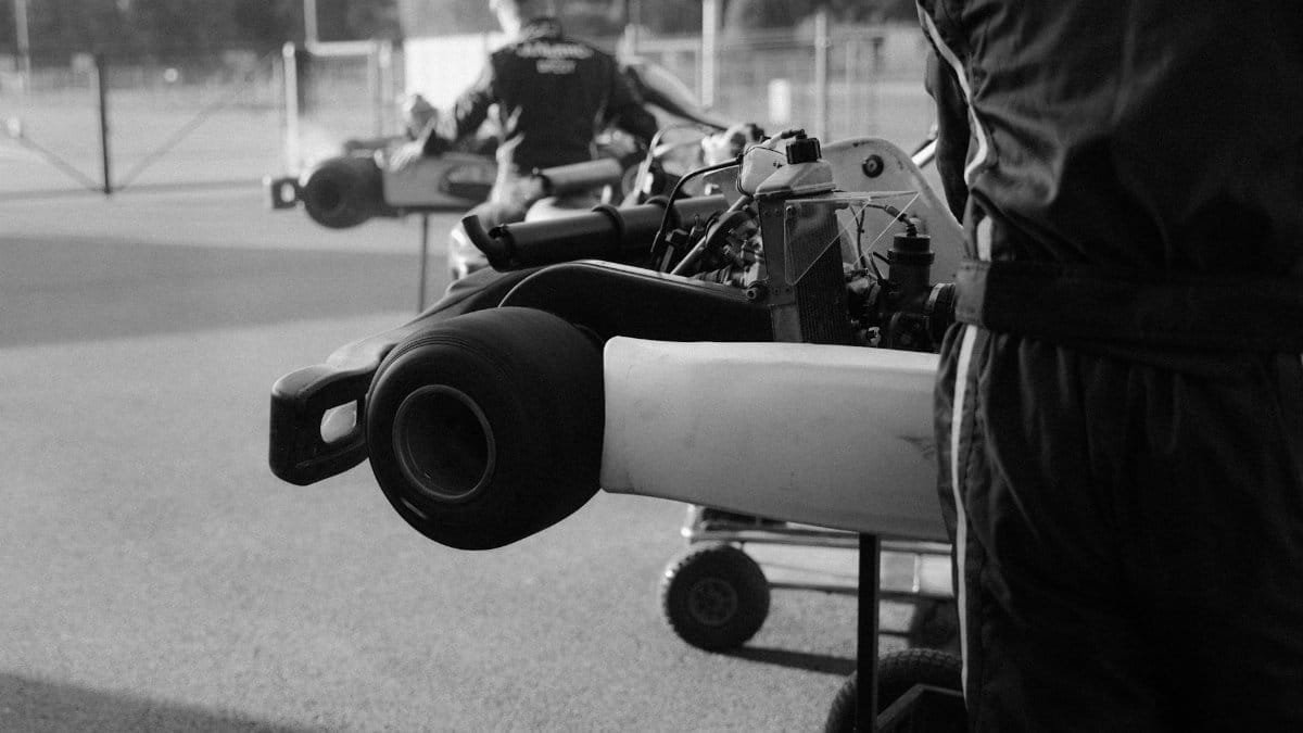 Monochrome view of racers preparing their go-karts for a competition.