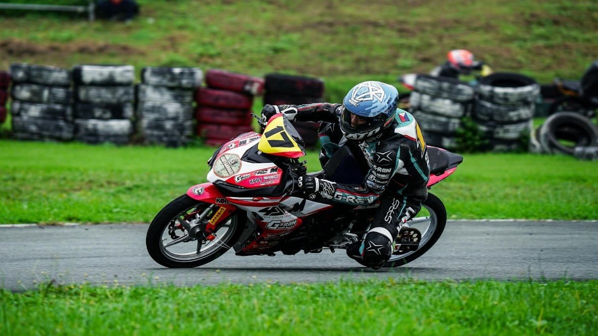 Motorcycle racer taking a sharp turn on a track in Tarlac City, Philippines.