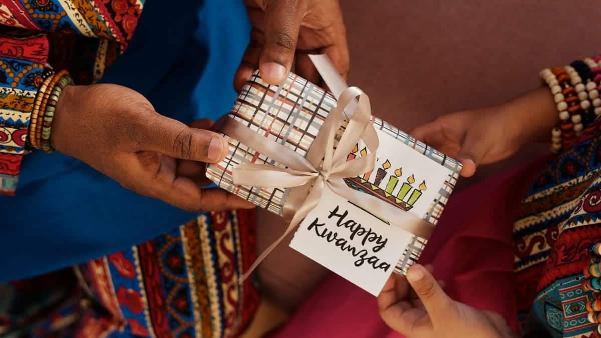Celebrating Kwanzaa with a gift exchange wrapped in festive patterns, highlighting cultural traditions.