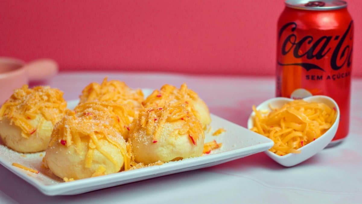 Delicious cheesy snacks served with Coca-Cola on a white tray. Perfect for a tasty snack time.