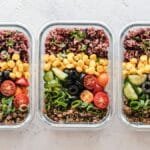 Colorful healthy meal prep with corn, olives, tomatoes, and lentils in glass containers. Perfect for mindful eating.
