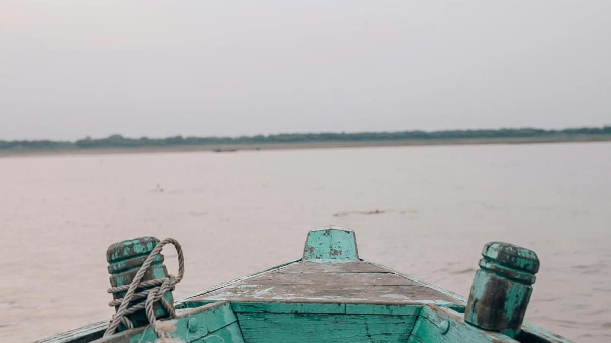 Tranquil view from a wooden boat on a calm river at dusk.