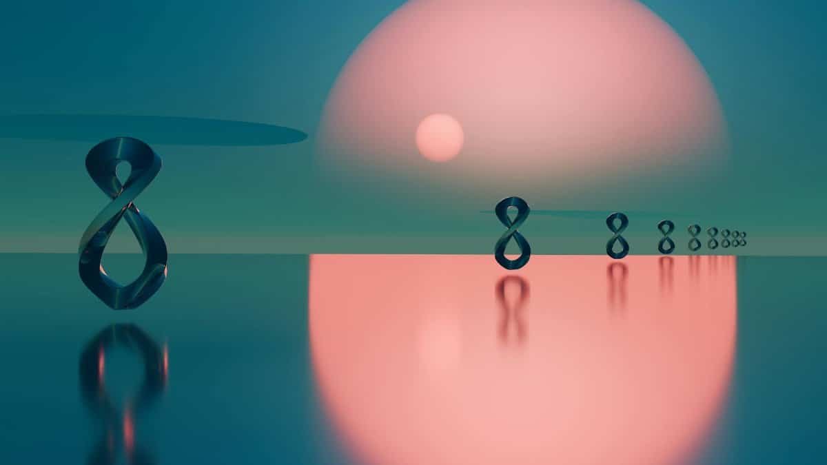 Surreal abstract scene with metal loops reflecting on water at sunset.