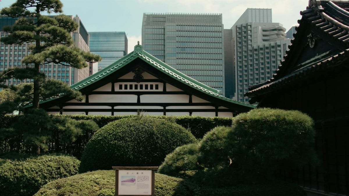 A serene blend of traditional Japanese architecture and modern skyscrapers in the background.