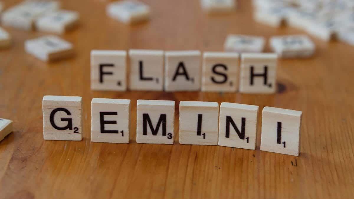 Wooden Scrabble tiles spelling 'Gemini' arranged on a wooden table.