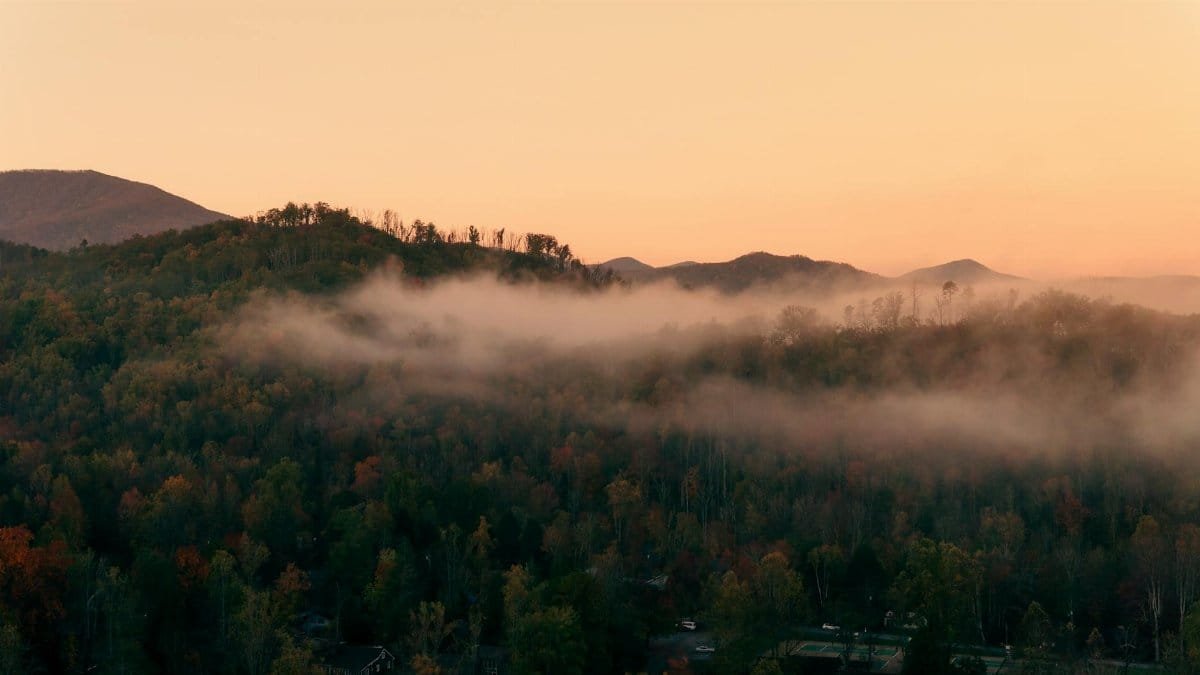 A serene mist-covered mountain landscape in Gatlinburg, Tennessee during autumn.