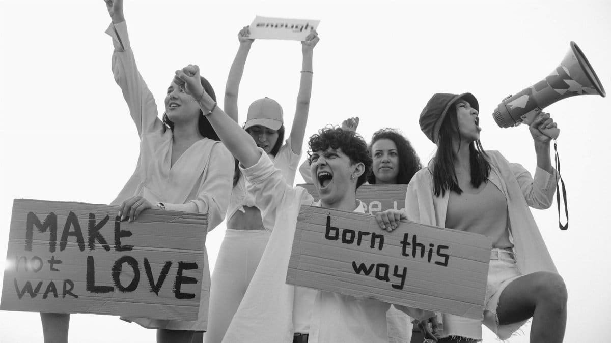 Youthful protestors demand love and equality with signs and megaphones.
