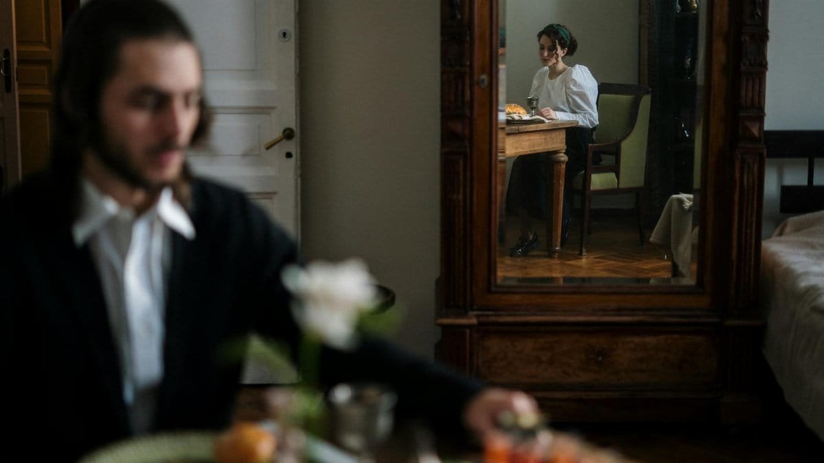Captivating moment of a couple seen through a mirror, adding depth to home interior vibe.