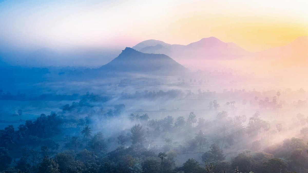 A breathtaking misty morning view of the landscapes and hills in Tuni, AP, India at dawn.