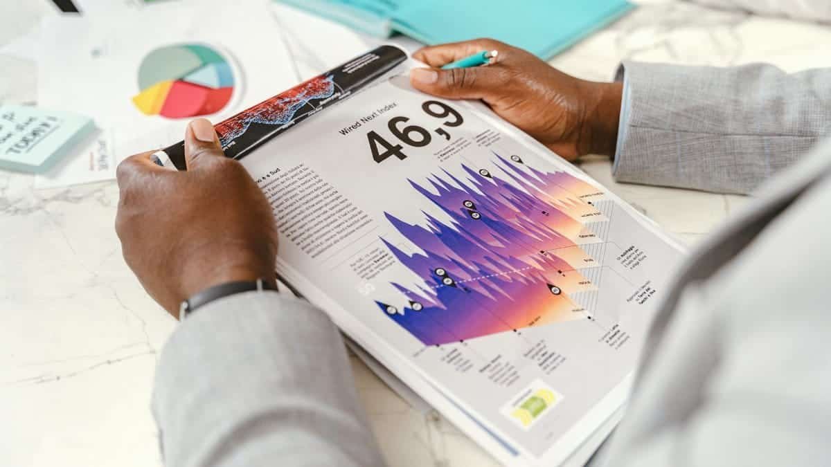 Close-up of a businessman analyzing colorful statistical data in an office setting.