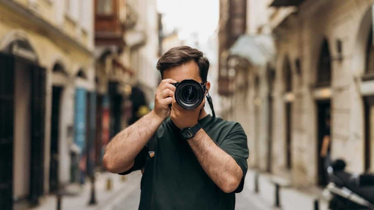 Man photographing in an Istanbul alley, showcasing urban street vibes and cultural architecture.