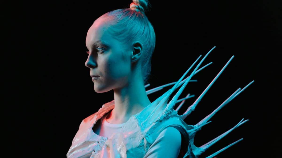 Conceptual portrait of a woman in a futuristic outfit with neon lights.
